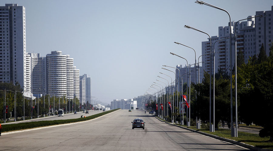 Taxis are driven on an almost empty avenue in central Pyongyang, North Korea