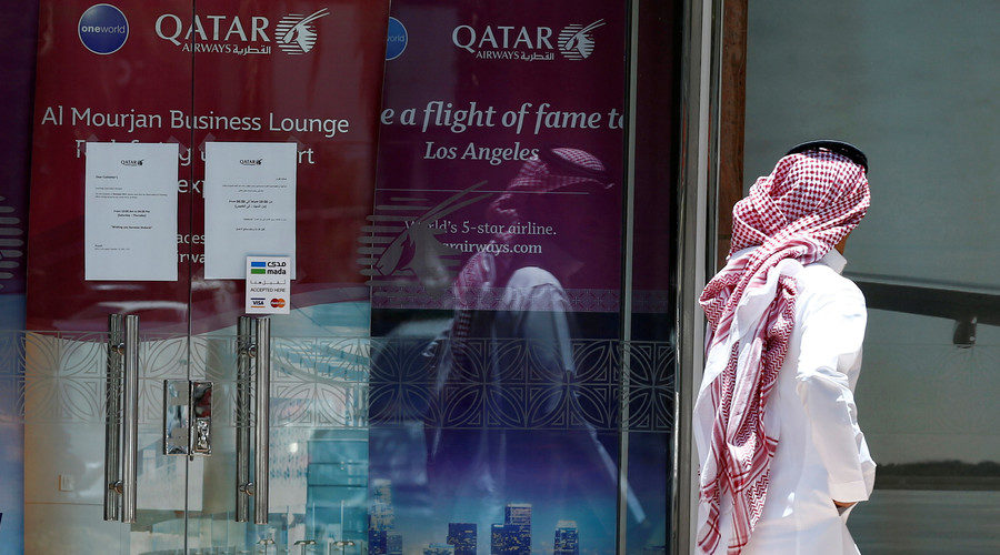 A man walks past Qatar Airways office in Riyadh, Saudi Arabia