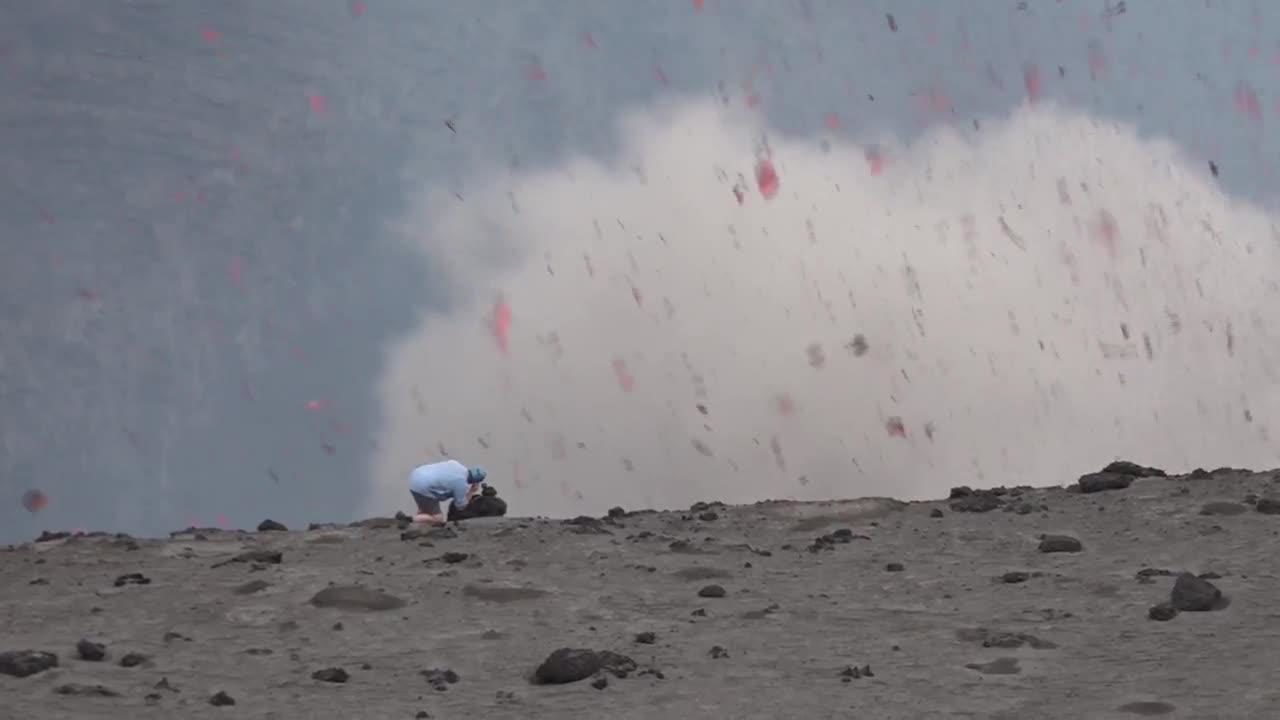 Click to enlarge Volcano erupts in front of man