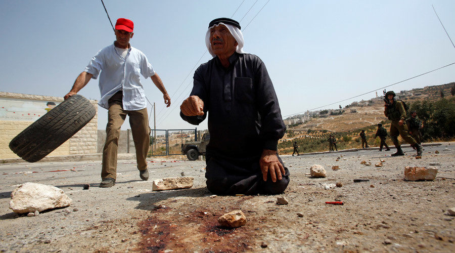 Palestinian man gestures where man was shot dead