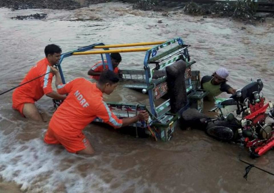 National Disaster Response Force comes to the aid of a villager in a flood-hit area in Morbi district on Monday.