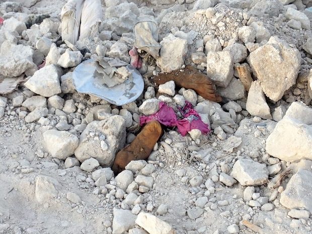 Click to enlarge Feet poke from the rubble of the Old City of Mosul