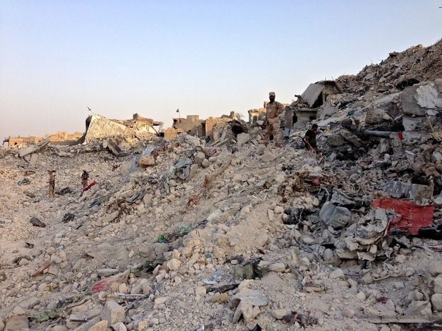 Iraqi soldiers pick through the rubble and ruins of the Old City