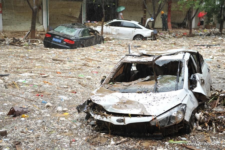Photo taken on July 27, 2017 shows damaged cars after a flood in Suide county of Yulin city, northwest China's Shaanxi Province. Six people are reported dead in a rain-triggered flood, local authorities said.
