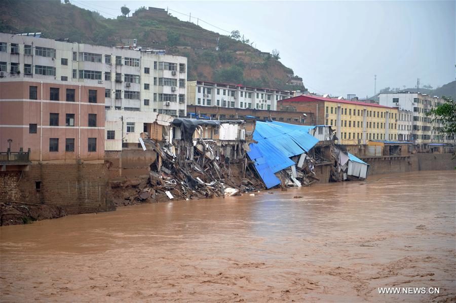 Photo taken on July 27, 2017 shows a damaged building after a flood in Suide county of Yulin city, northwest China's Shaanxi Province. Six people are reported dead in a rain-triggered flood, local authorities said.