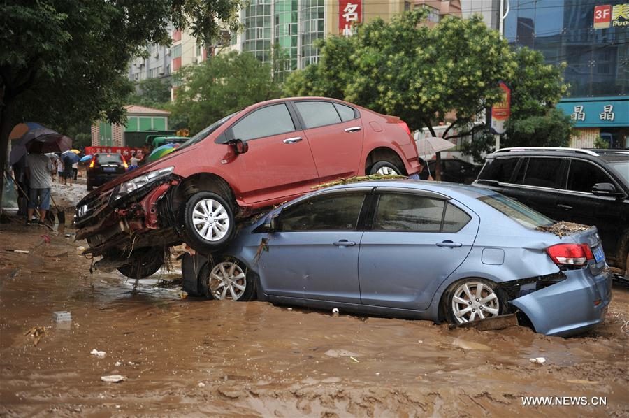 Photo taken on July 27, 2017 shows damaged cars after a flood in Suide county of Yulin city, northwest China's Shaanxi Province.