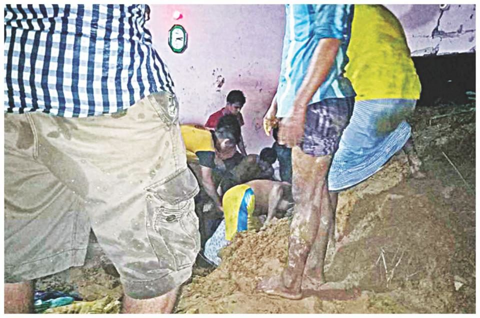 Locals look for survivors after a landslide hit a building in Lighthouse Para of Cox's Bazar early yesterday. Two people were killed and two others injured in the incident.