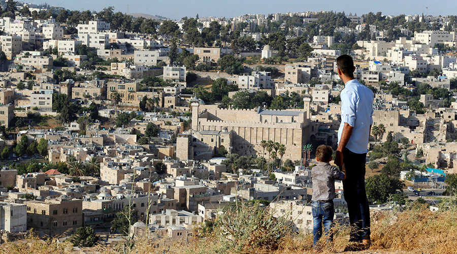 A general view as Palestinians look at the West Bank city of Hebron