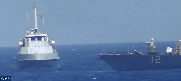 An Iranian vessel making a close approach to a US coastal patrol ship USS Thunderbolt, right.