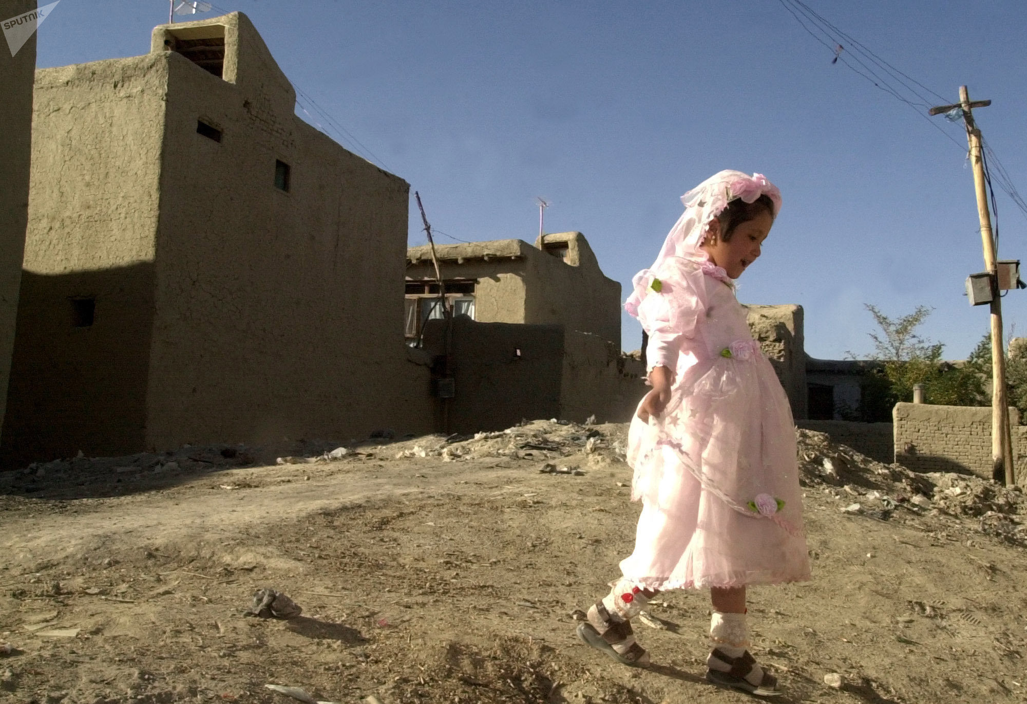Fareema,7, plays outside during a wedding party in Kabul, Afghanistan