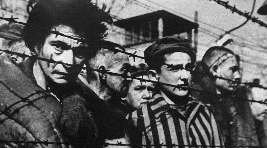 Click to enlarge A picture of inmates behind barbed wire taken in 1945 when the concentration camp of Auschwitz was liberated in Poland