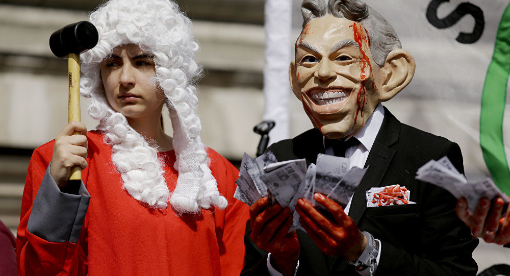 protesters wearing bloody Tony Blair mask