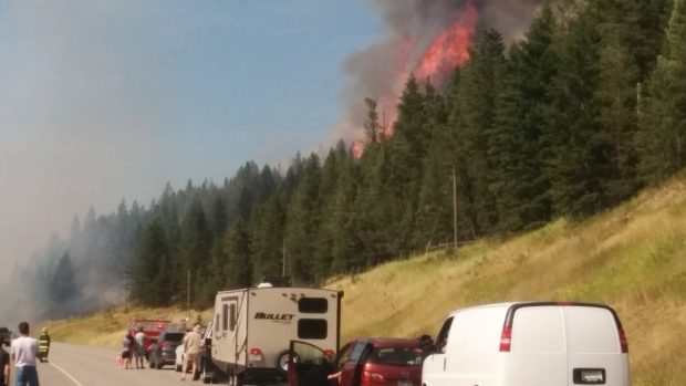 Click to enlarge Flames burn along Highway 95 south of Canal Flats.