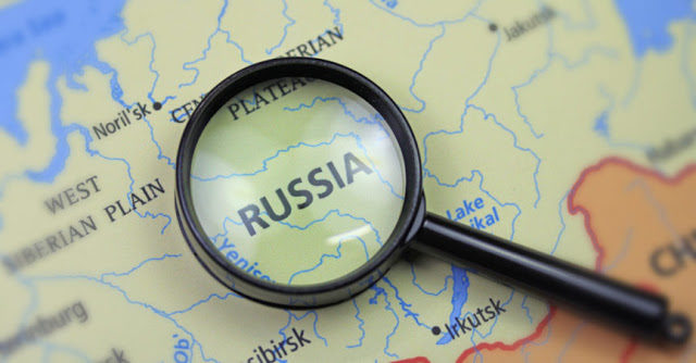 magnifying glass over map of Russia