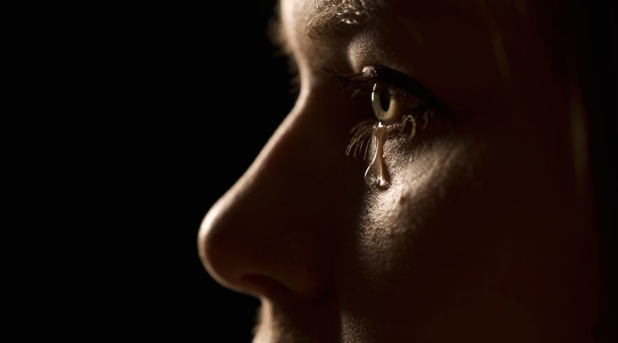 woman's face with a tear