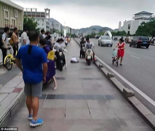 The scooter rider can be seen lying on the floor after being struck by lightning