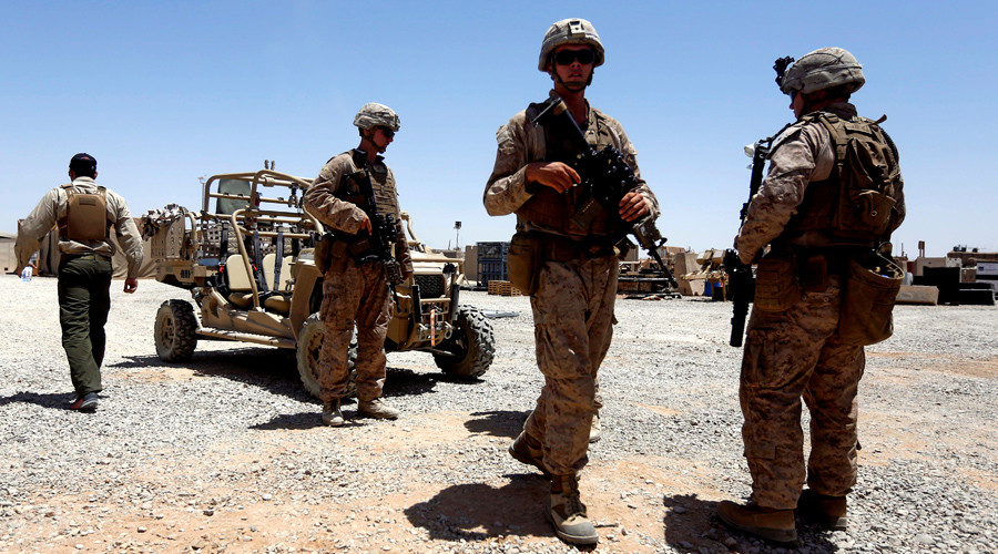 U.S. Marines walk inside their base after they are back from training with Afghan National Army