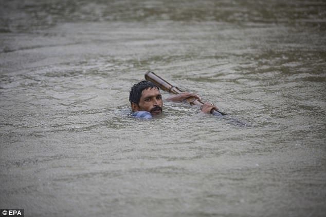 This man struggled to keep his head above water as the flooding submerges parts of Nepal