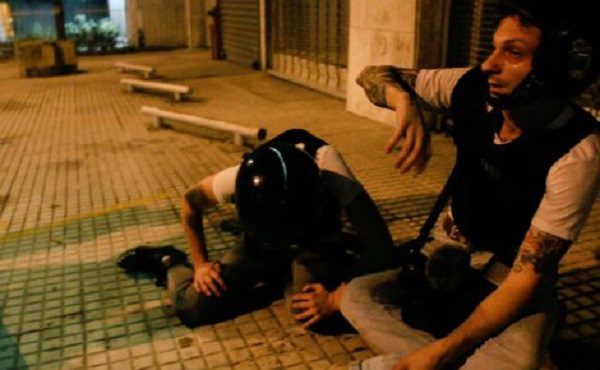 Mike Prysner and Abby Martin recovering from tear gas in Venezuela