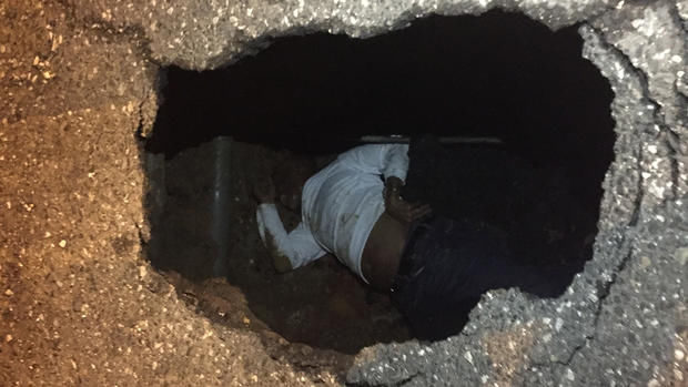 Eugene Clarke, a Strawberry Mansion block captain, was rescued after he fell down a sinkhole late Saturday night. Clarke's wife took a photo of him before firefighters pulled him out.