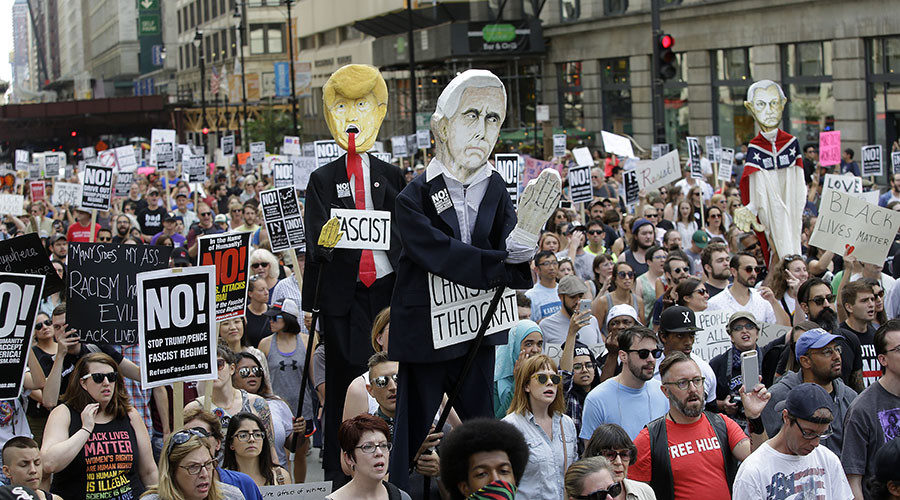 Demonstrators carry effigies of President Donald Trump and Vice President Mike Pence during a protest against hate, white supremacy groups in Chicago, Illinois.