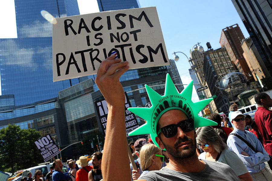 protester holds a sign reading 