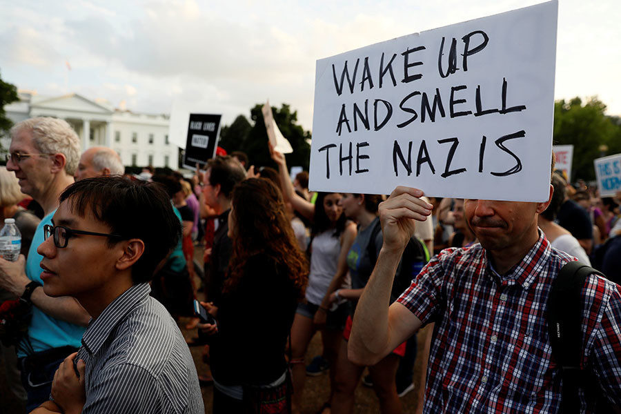People gather for a vigil in response to the death of a counter-demonstrator at the 