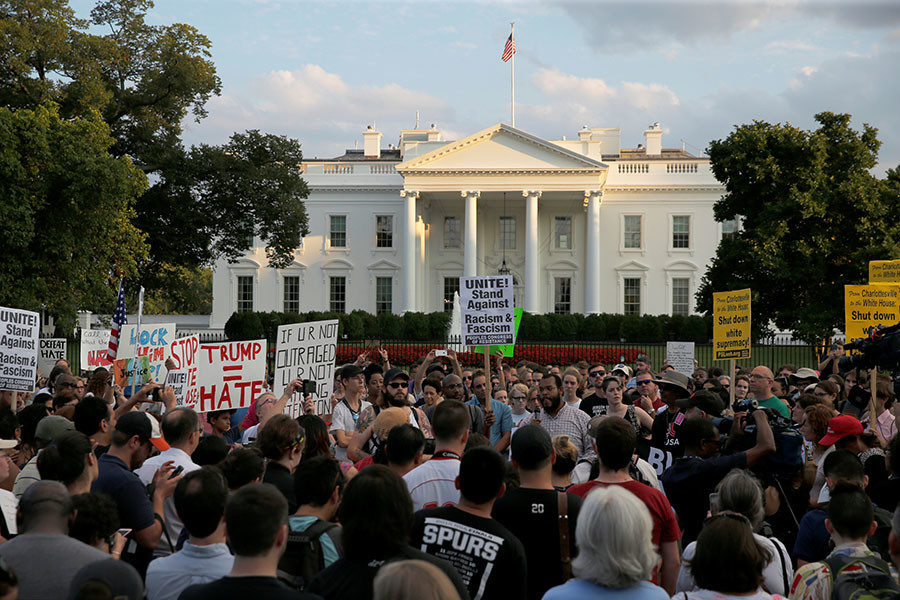 People gather for a vigil in response to the death of a counter-demonstrator at the 