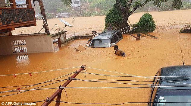 Click to enlarge Local media reports also said that a section of a hill in the Regent area of the city had partially collapsed. Pictures showed people wading through deep water and cars submerged in the flooding