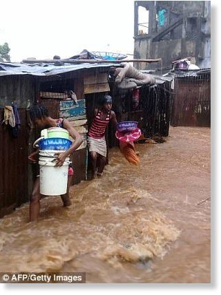Click to enlarge Videos posted by local residents showed people waist and chest deep in water trying to traverse the road
