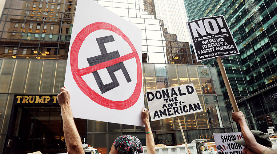 Protesters wave anti-Trump signs during protests in front of Trump Tower