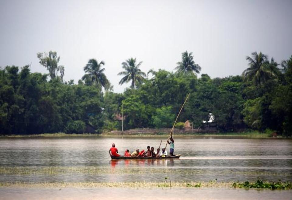 Villagers ride a boat in a flood-affected area in Saptari district, Nepal, on August 14, 2017.