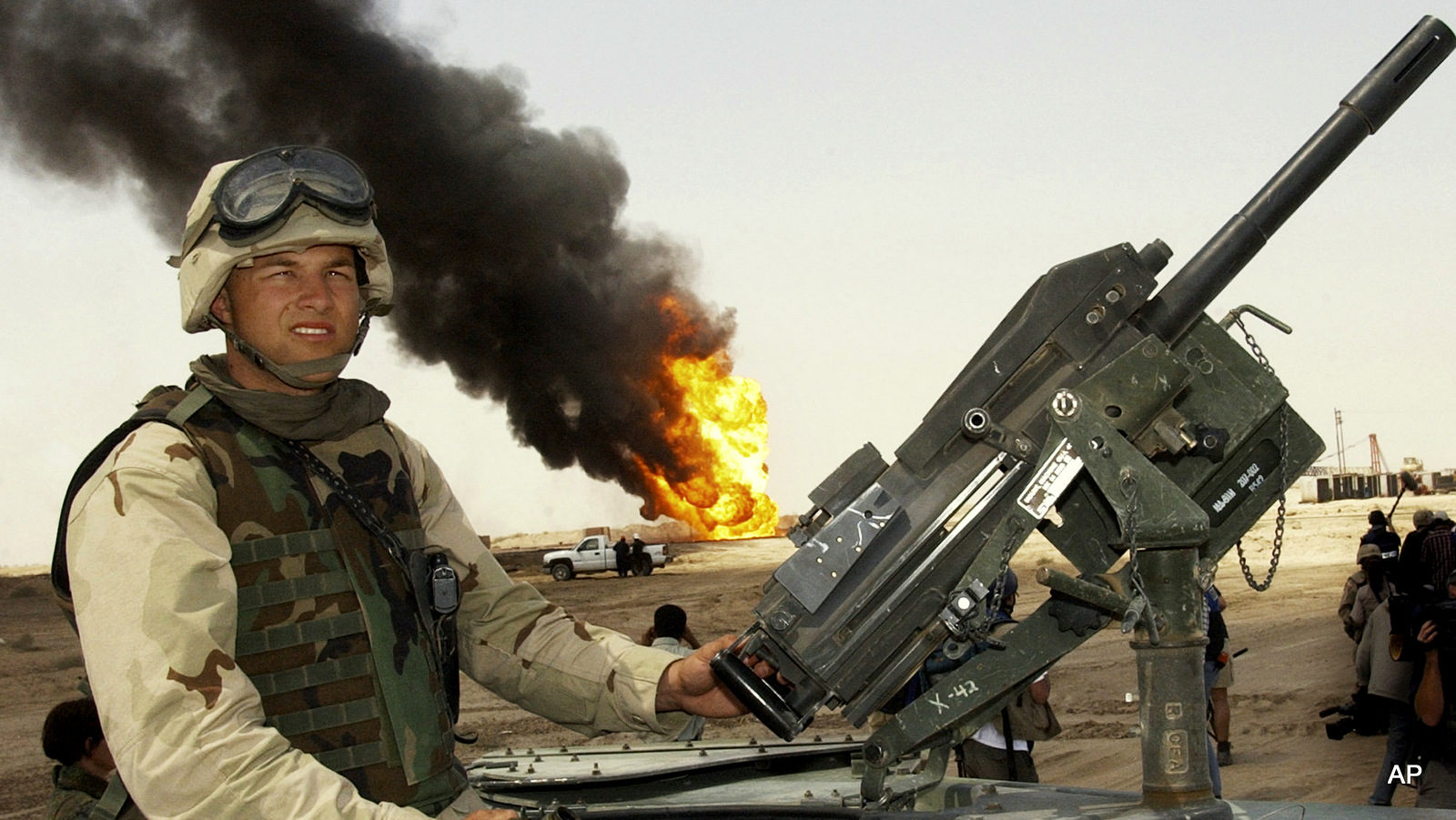 U.S. soldier stands guard on top of a humvee
