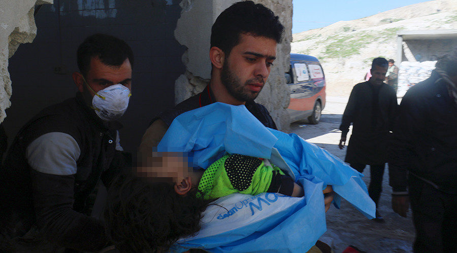 man carries the body of a dead child, after gas attack in the town of Khan Sheikhoun, Idlib, Syria