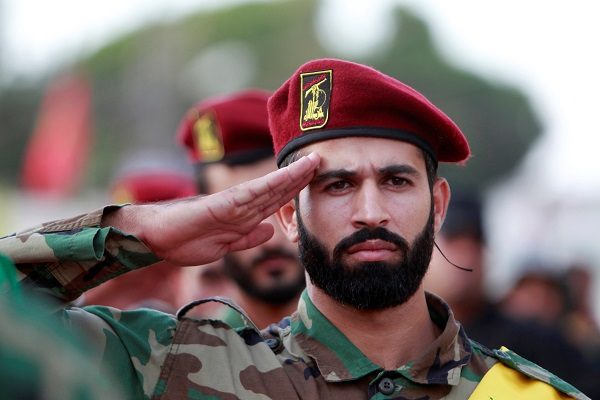 Click to enlarge Hezbollah members salute
