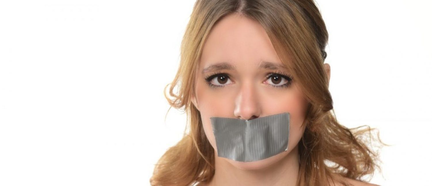 Woman with tape over her mouth