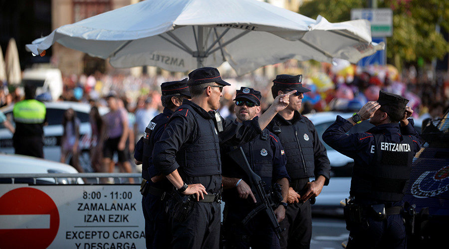 Police officers stand at a road block at the beginning of fiestas in Bilbao