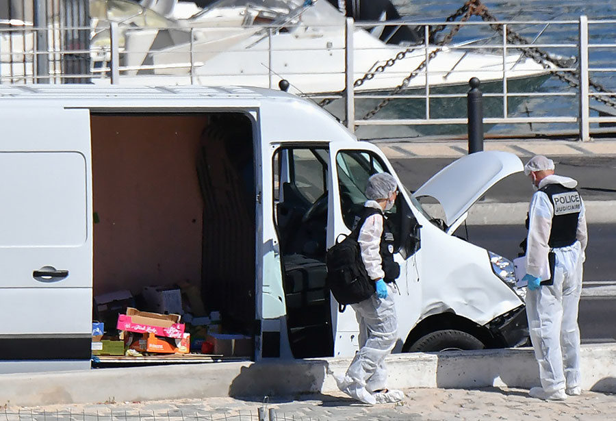 French forensic police officers search a vehicle following a car crash in the southern Mediterranean city of Marseille