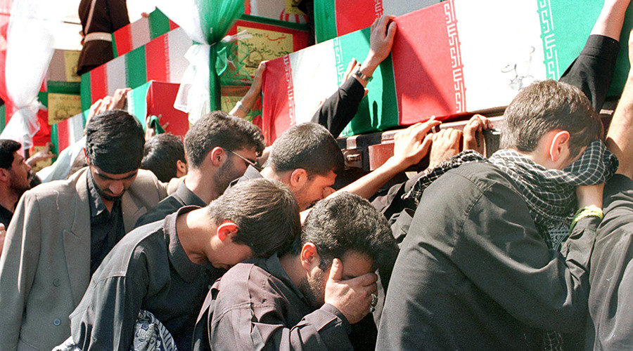 Iranians cry during a mass funeral in Tehran for 315 soldiers killed during the 1980-88 war with Iraq