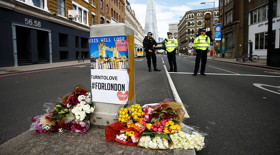 Flowers and messages lie behind police cordon tape near Borough Market, London
