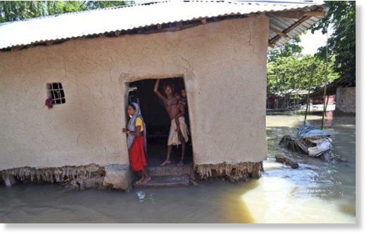 Click to enlarge Villagers stand inside their house destroyed by floodwaters at Katihar district, in the eastern Indian state of Bihar, on Saturday 19 August 2017.