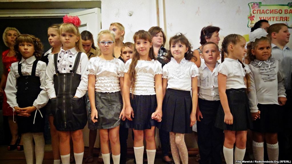Students arrive for the first day of school in Pervomayske, near the Donetsk airport