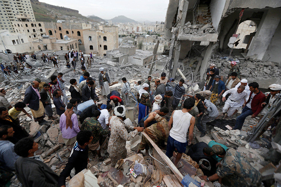 Click to enlarge People search under rubble of a house destroyed by a Saudi-led air strike in Sanaa, Yemen