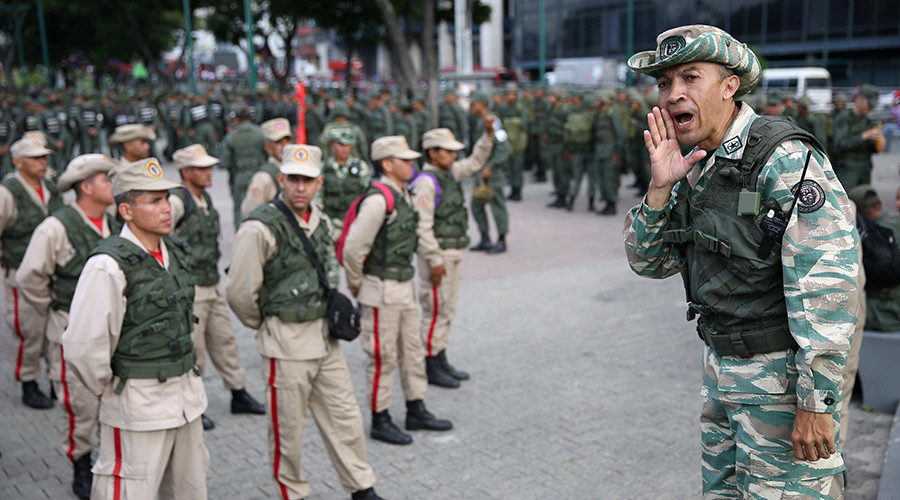 Members of the National Bolivarian Militia get ready before a military exercise in Caracas