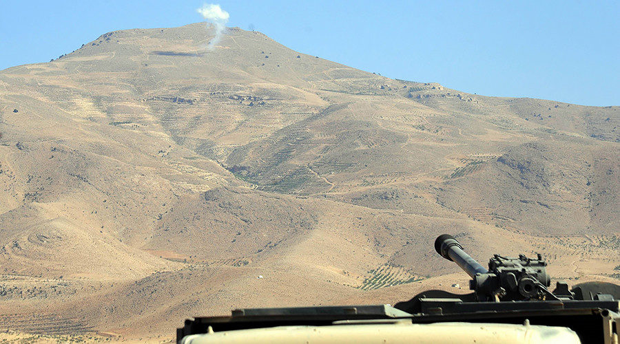 Click to enlarge Smoke rises from a position of the Islamic State (IS) group in Syria