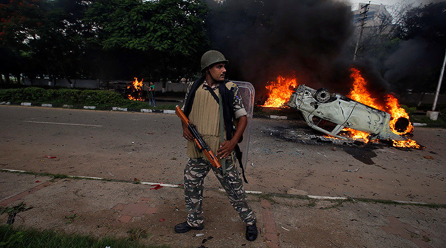 A member of the security forces reacts during violence in Panchkula, India