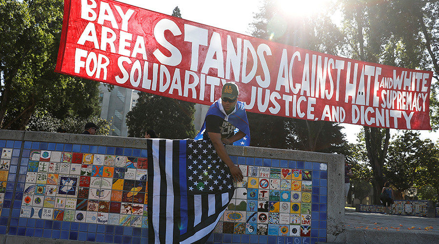 A supporter of U.S. President Donald Trump places a flag in Martin Luther King Jr. Civic Center Park