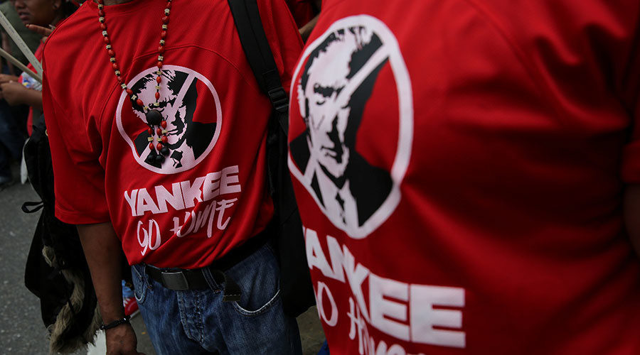 Click to enlarge Civilians wear T-shirts with the face of US President Donald Trump