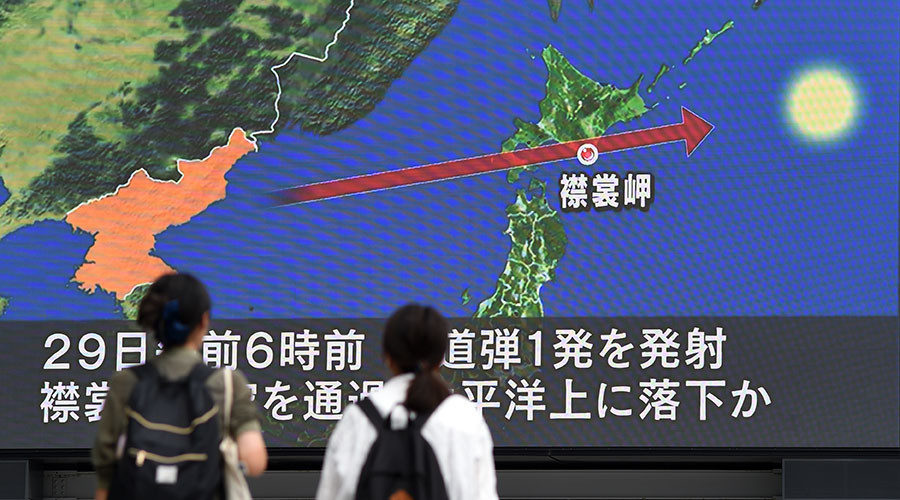 Click to enlarge Pedestrians watch the news on a huge screen displaying a map of Japan (R) and the Korean Peninsula, in Tokyo on August 29, 2017.