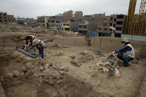 Archeologists work at the site where 16 tombs belonging to 19th century Chinese immigrants were discovered